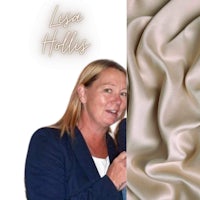 a woman is standing next to a piece of fabric