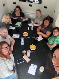 a group of women sitting around a table