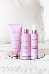 a set of pink products on a bed