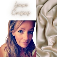 a woman is posing in front of a piece of fabric