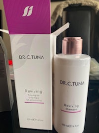 a bottle of dr c tuna reviving cleanser on a table
