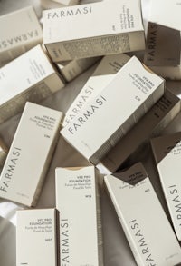 farmasi skin care products on a white bed