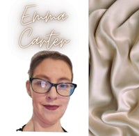 a woman in glasses is standing next to a piece of fabric