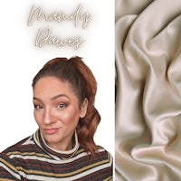 a woman is posing in front of a striped sweater