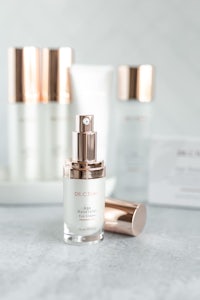 a collection of skincare products on a marble table