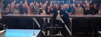 a group of people standing in front of a bar with the words nl evolution